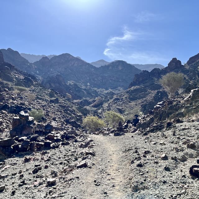 Trail heading into rocky mountain landscape.